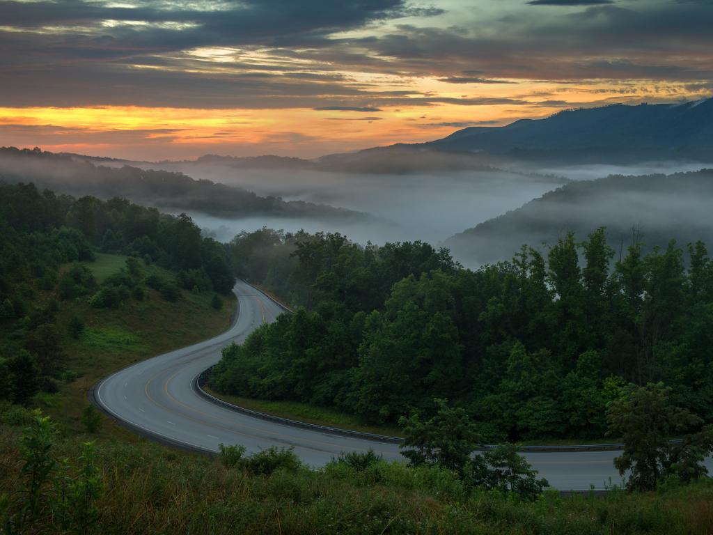 Appalachian Mountains, North Carolina, USA taken on a morning over winding country road with the mountains in fog in the distance.