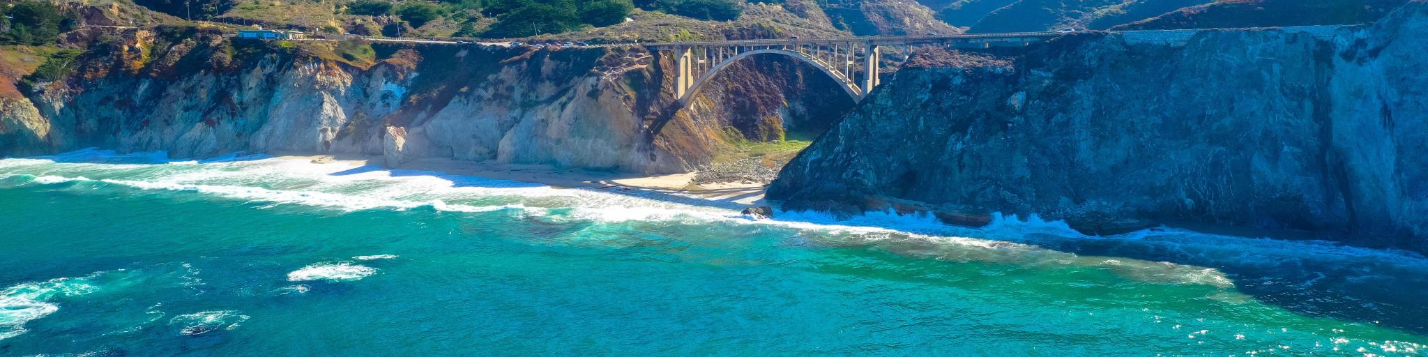 Pacific Coast Highway at Bixby Bridge. Long-range shot with the sea in the foreground