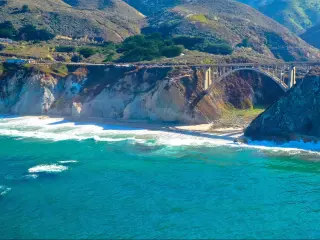 Pacific Coast Highway at Bixby Bridge. Long-range shot with the sea in the foreground