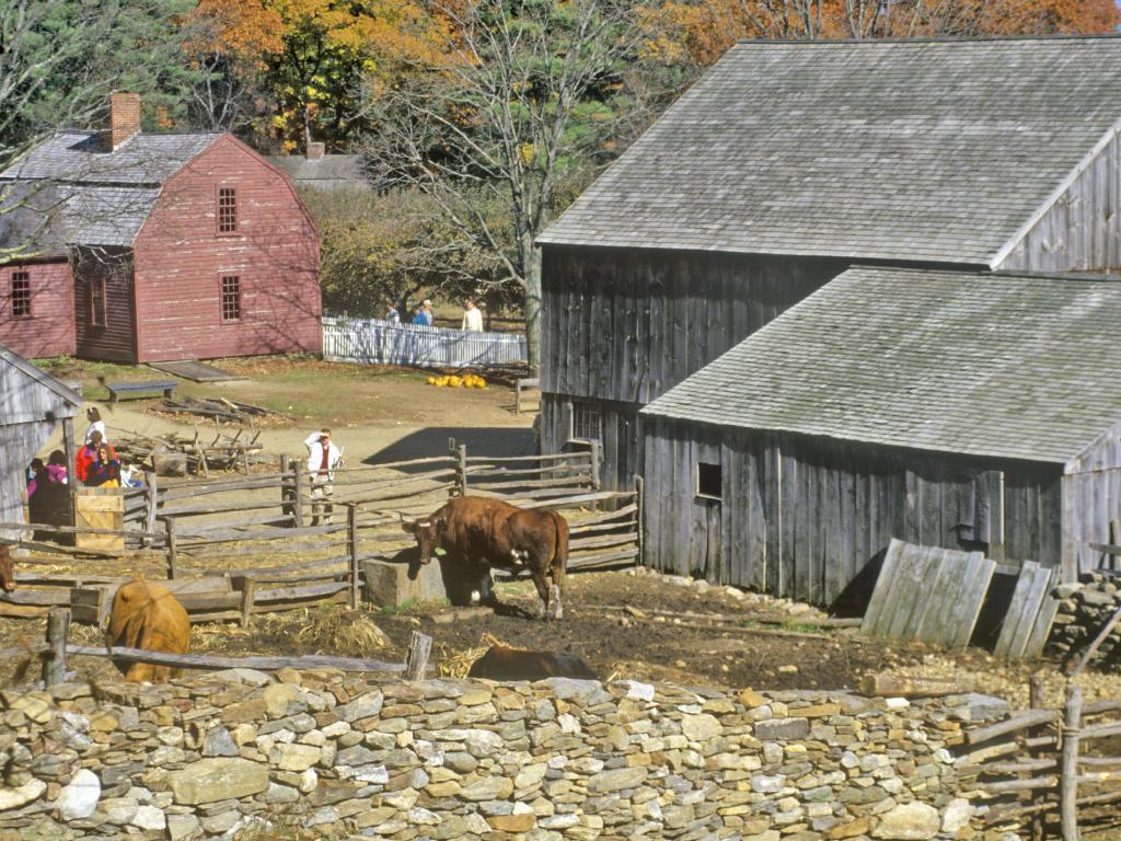 1900s recreation Old Sturbridge Village, Sturbridge, Massachusetts with wooden buildings and people dressed in period costume