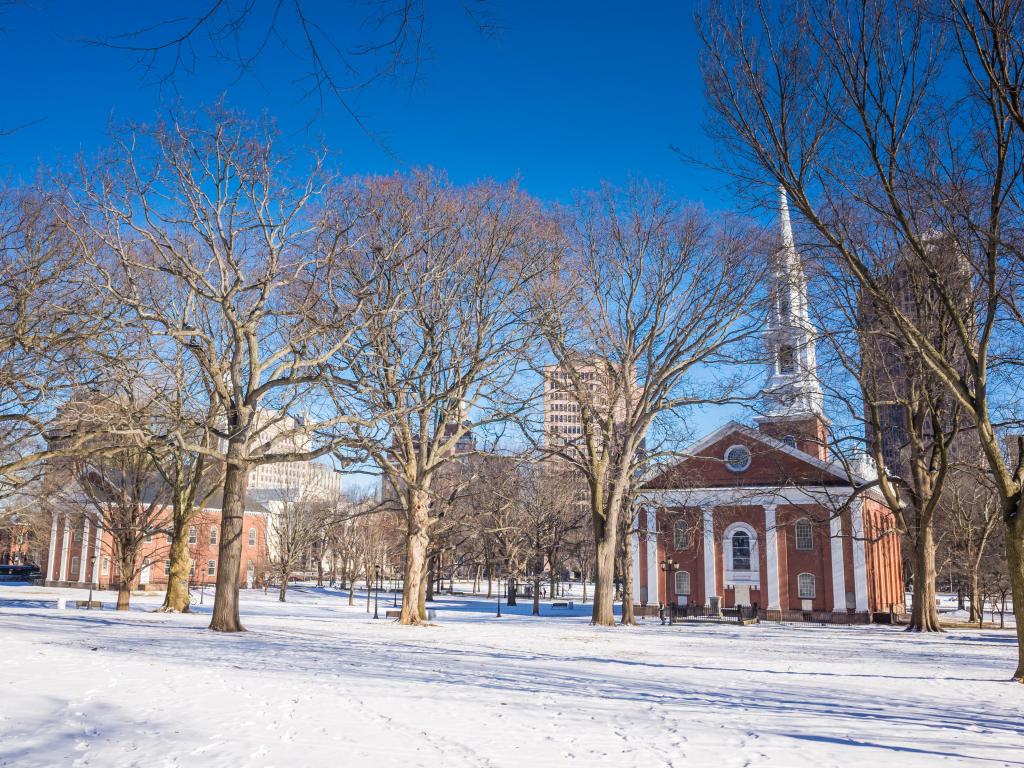 Historic brick buildings in the snow with blue sky and bright sunshine