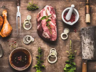 Table full of meat, spices and tools for every BBQ style