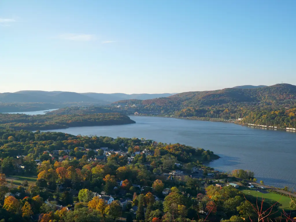 Hudson River, New York, USA with a beautiful scenic overlook view of Hudson River valley on an autumn morning, sunrise over the hills. Fall foliage on trees throughout the countryside.