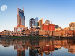 Skyline of the city in the morning with the moon seen in the background