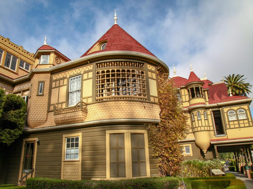 Facade of the famous house with the door to nowhere in sight on a partially cloudy day