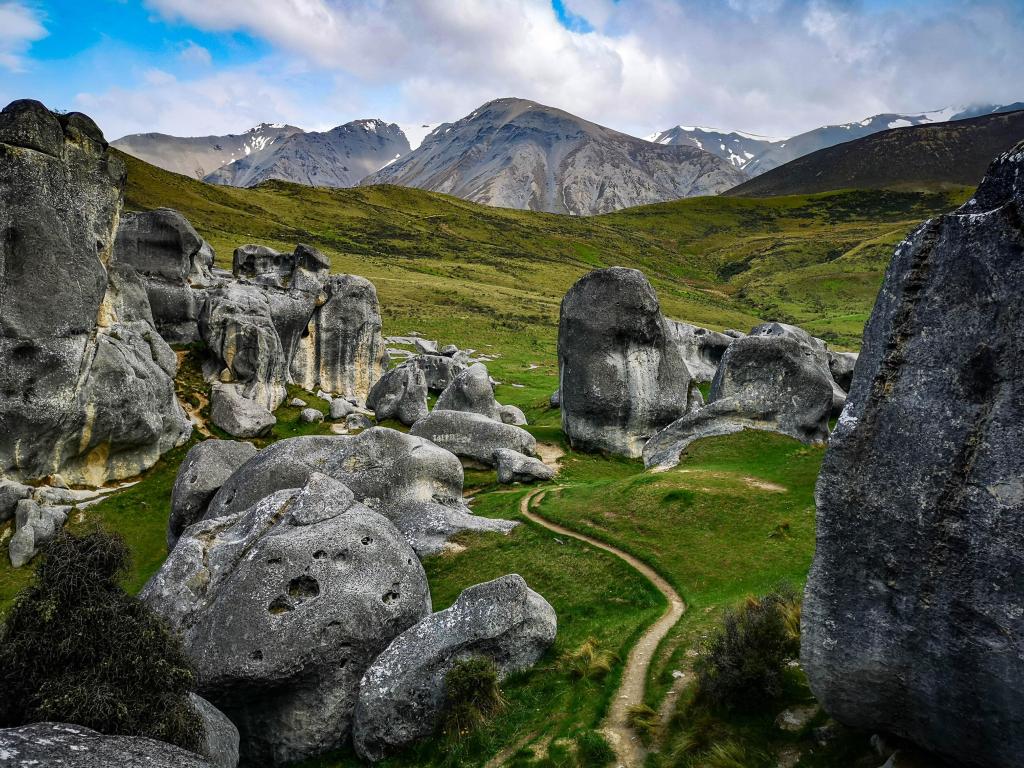 Arthur's Pass, New Zealand with boulders of Castle Hill and mountains in the distance.