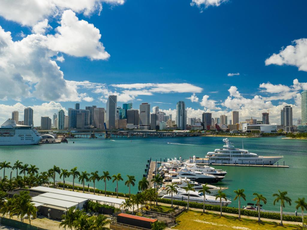 Miami, Florida, USA taken as an aerial scenic image of downtown Miami and Island Gardens Marina on a sunny day.