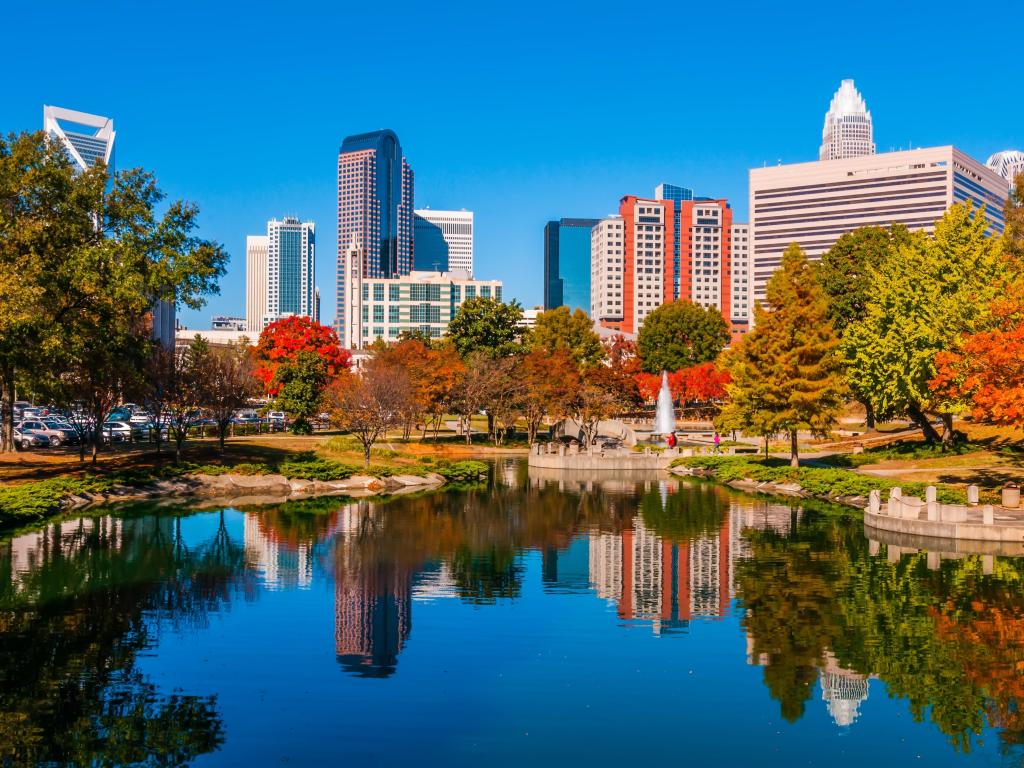 A view of the Charlotte, NC skyline with the lake of Marshall Park and autumn colour in the foreground.