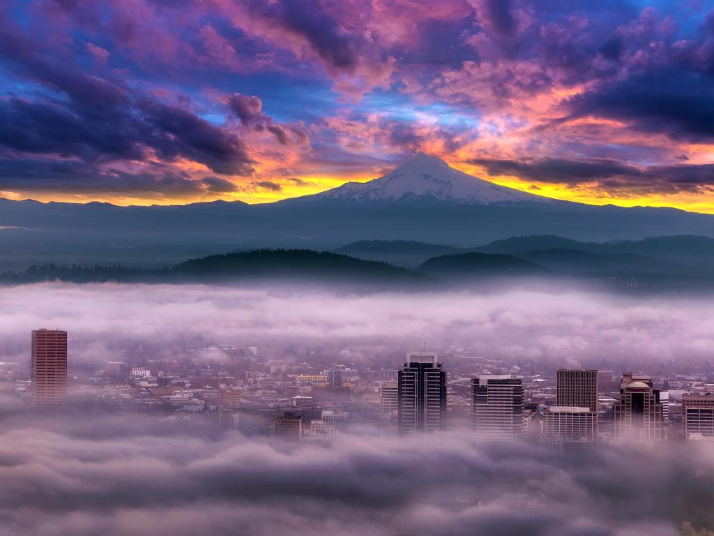 Dramatic colorful sunrise over Mount Hood and foggy Portland Oregon city downtown