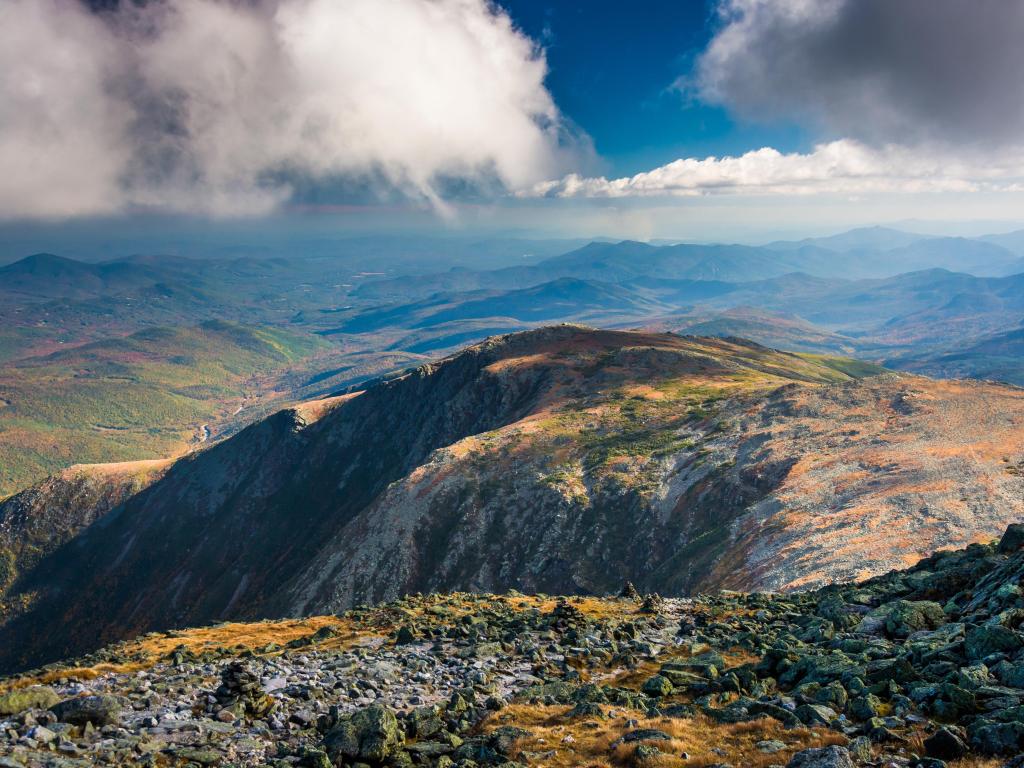 Mount Washington, New Hampshire, USA wit a view of the rocky, rugged White Mountains from the summit on a cloudy but sunny day.