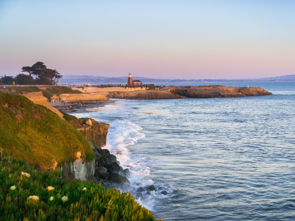 Santa Cruz, California, USA with a sunset view of the Pacific Ocean rugged coastline.