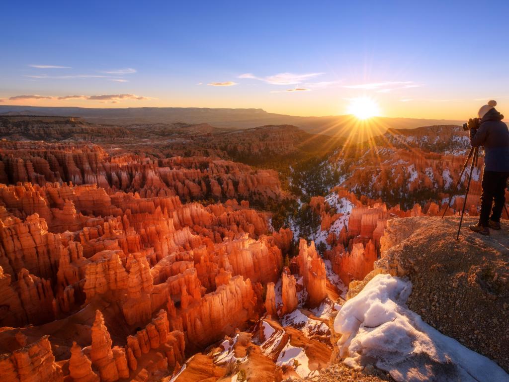 View of Bryce Canyon with snow covering the red rocks at sunrise