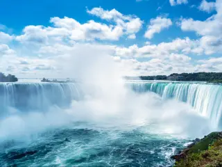 Niagara Falls, Ontario, Canada with a view of Horseshoe Fall on a sunny day.