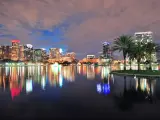 Orlando downtown skyline over Lake Eola at dusk with urban skyscrapers and lights.