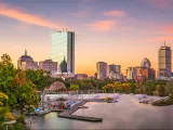 Boston, Massachusetts, USA with the skyline in the background and the harbor in the foreground taken at dawn.
