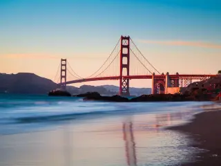 Golden Gate bridge during sunset, with the tide going out