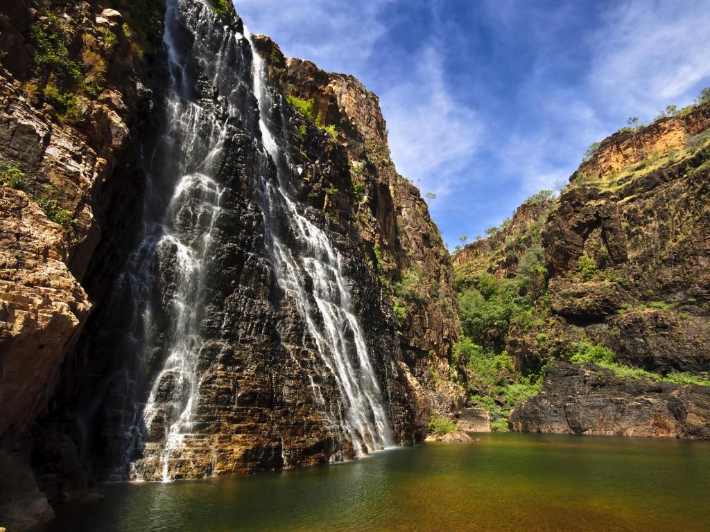 Twin Falls, Kakadu National Park, Australia with a huge cliff and waterfall taken on a sunny day.