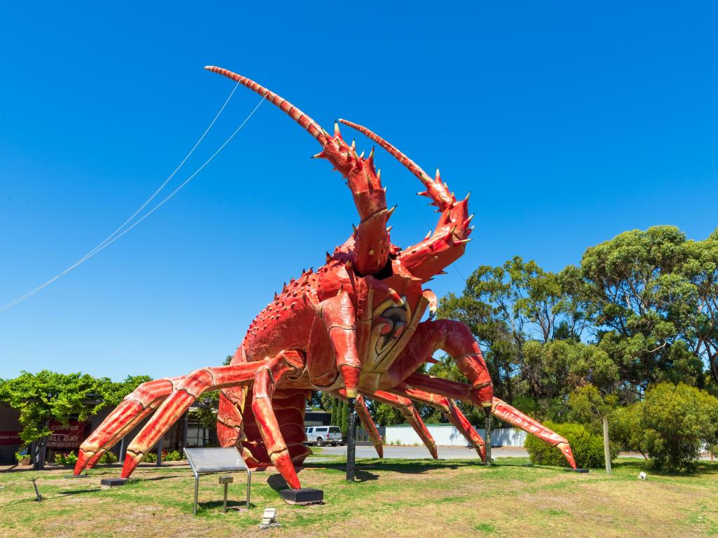 Steel and fiberglass sculpture of a lobster, known as Larry the Lobster locally, on a sunny day