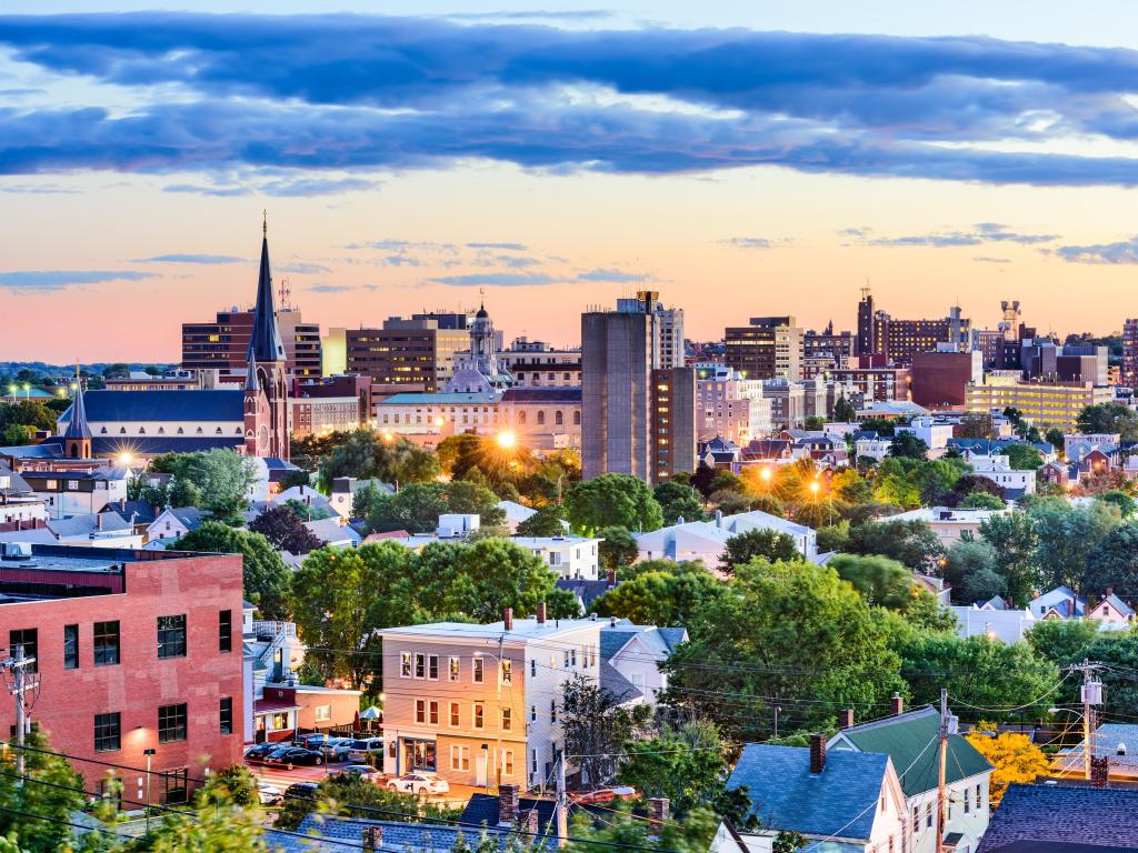 Portland, Maine, USA with the downtown skyline taken after sunset with a beautiful sky and street lights lighting up the city.