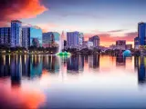 Orlando, Florida with Eola Lake in the foreground and the city buildings reflecting in the background at sunset.