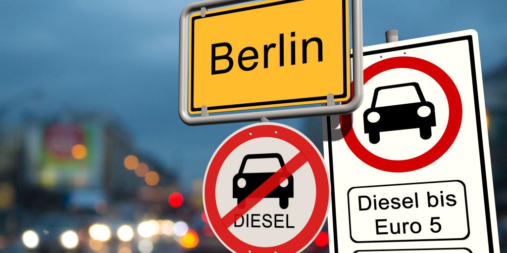 A red and white round road sign in Berlin indicating that old diesel cars are prohibited in that area