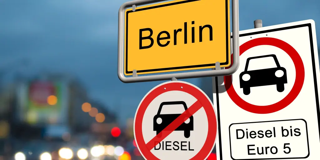 A red and white round road sign in Berlin indicating that old diesel cars are prohibited in that area