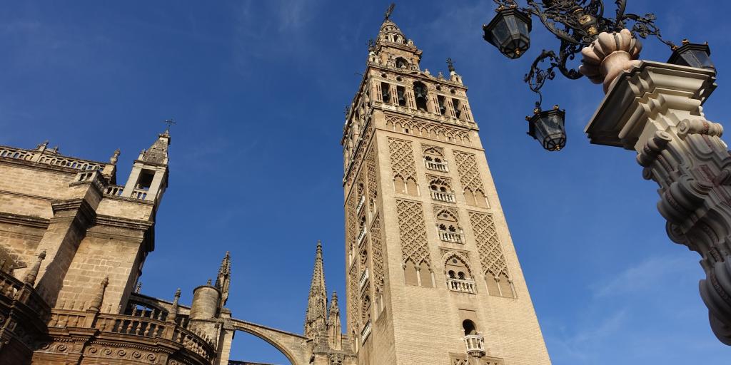 The La Giralda bell tower in Seville stands tall next to the cathedral