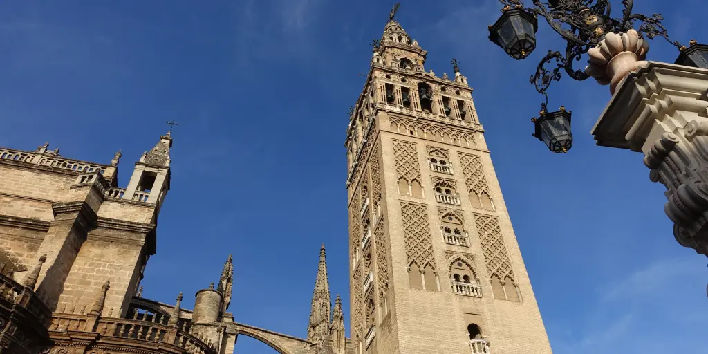 The La Giralda bell tower in Seville stands tall next to the cathedral