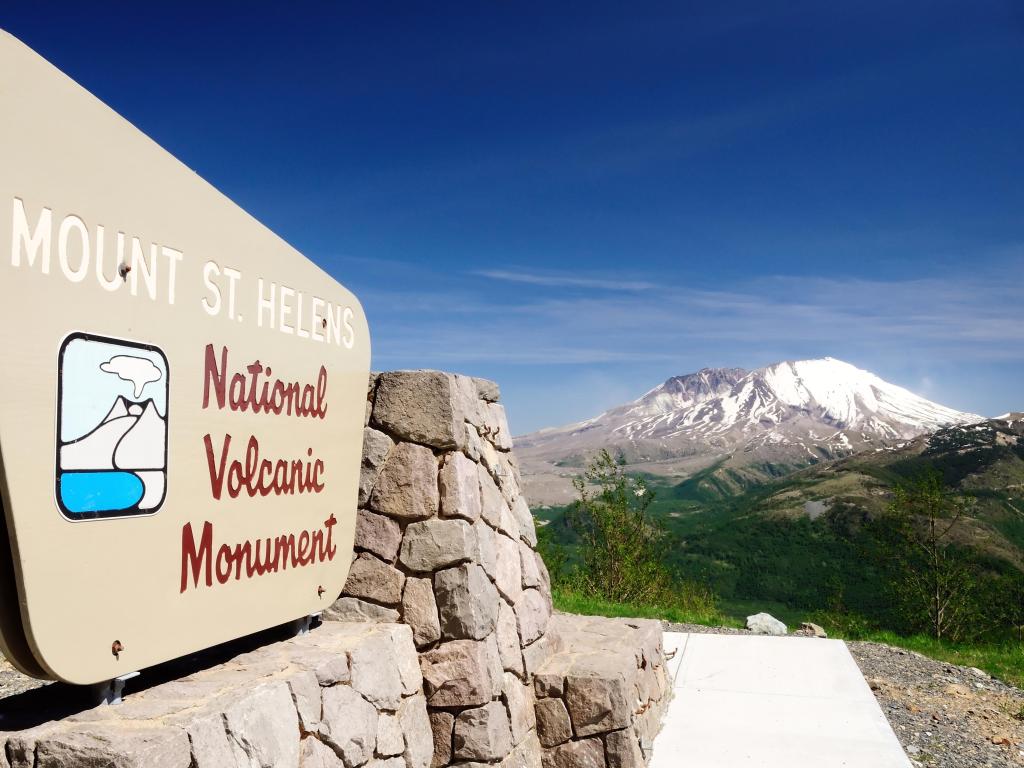 Mount St. Helens National Volcanic Monument viewpoint overlooking volcano and monument signage in forefront
