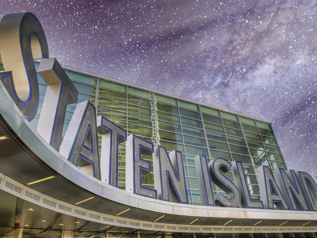 Close up of Staten Island Ferry Entrance Sign under a starry night
