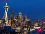 Panoramic view of Seattle at night with lights showing from high rise buildings 