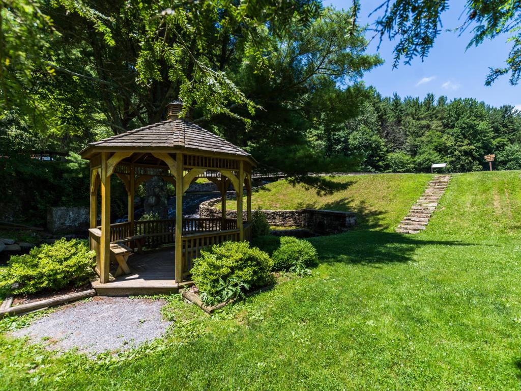 Landscape of the swimming and fishing area with grassy bank and pergola in Colonel Denning State Park in Tuscarora State Forest in Pennsylvania