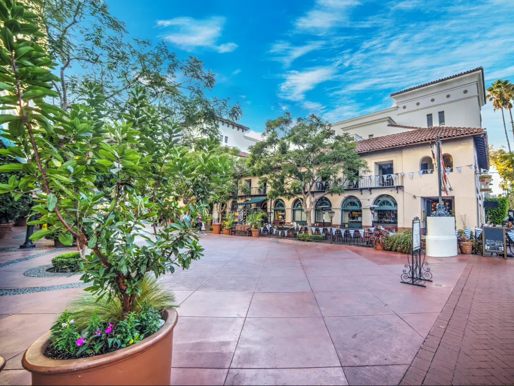A typical square in Santa Barbara with restaurant tables outside in perfect weather.