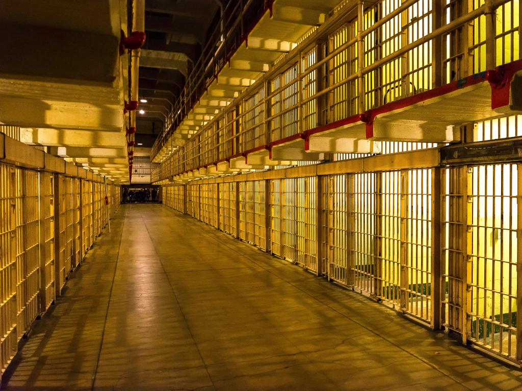 Inside the prison, a row of prison cells at night