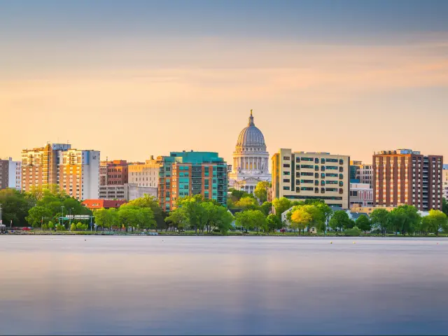 Madison, Wisconsin, USA downtown skyline at dusk on Lake Monona.