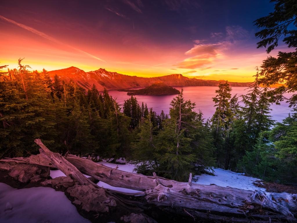 Crater Lake National Park Wizard Island and Watchman Peak Oregon at a colorful and clear sunset.