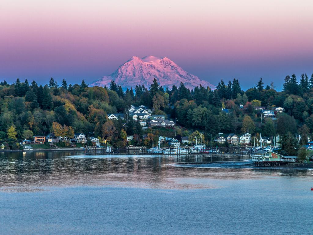 Mt Rainier looms in the background of a sunset shot of Olympia, Washington