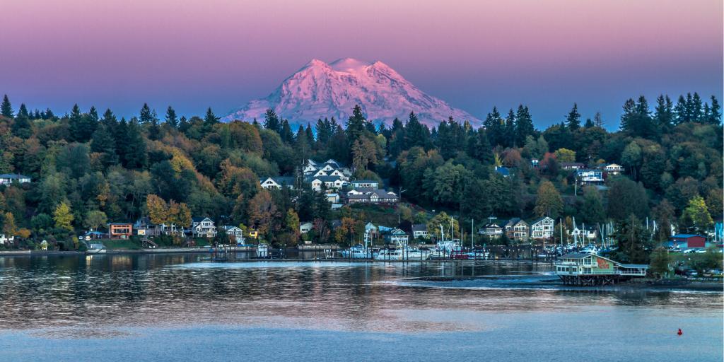 Mt Rainier looms in the background of a sunset shot of Olympia, Washington