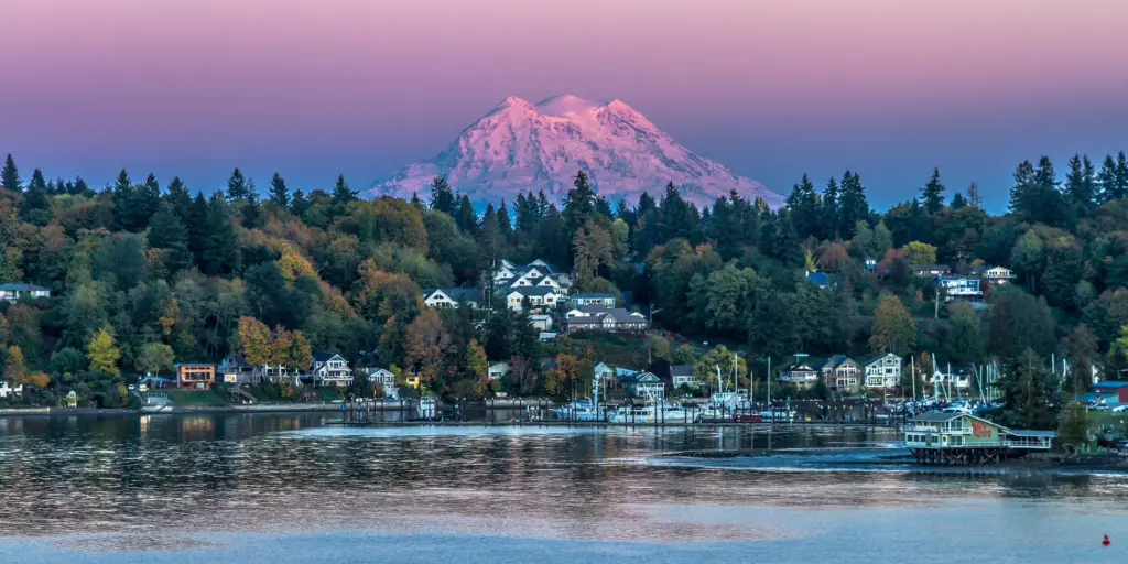 Mt Rainier looms in the background of a sunset shot of Olympia, Washington