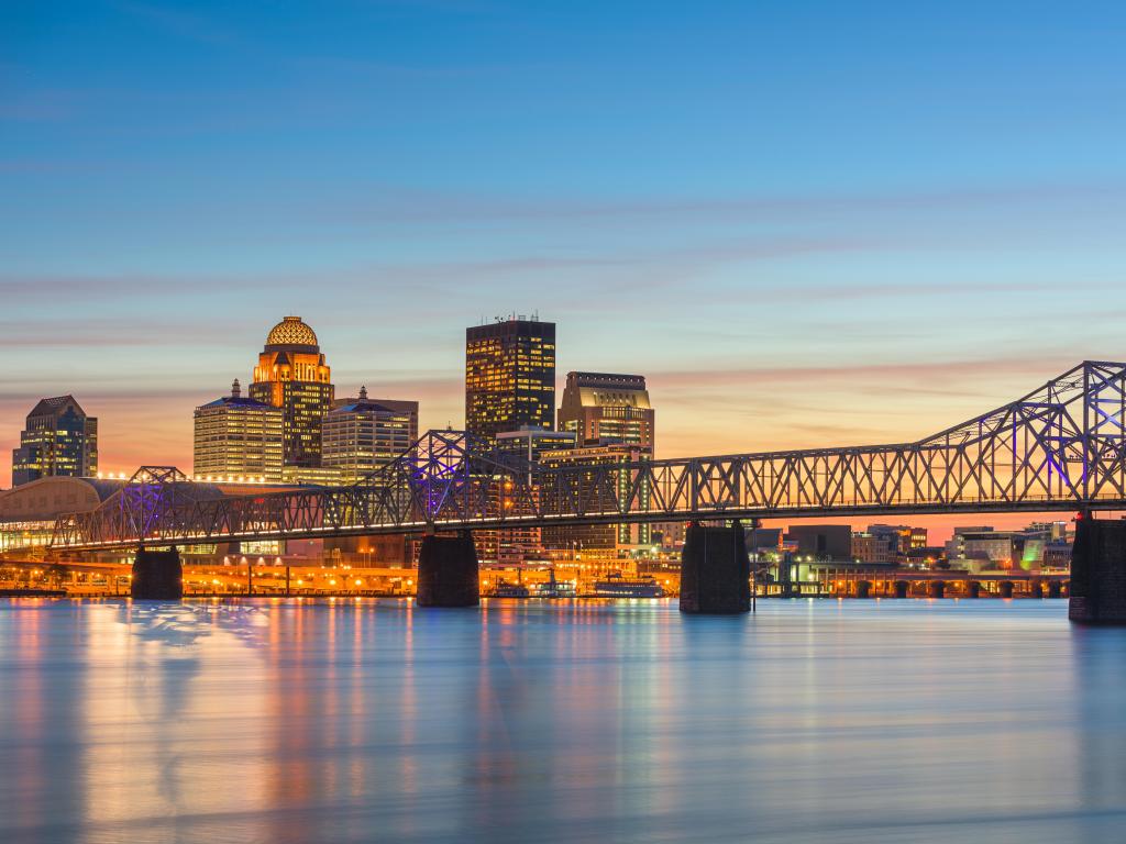 Louisville, Kentucky, USA with the skyline in the background and the river and bridge in the foreground taken at early evening.