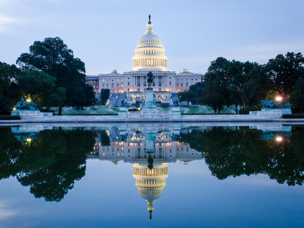 Washington DC, US Capitol Building in a cloudy sunrise with mirror reflection