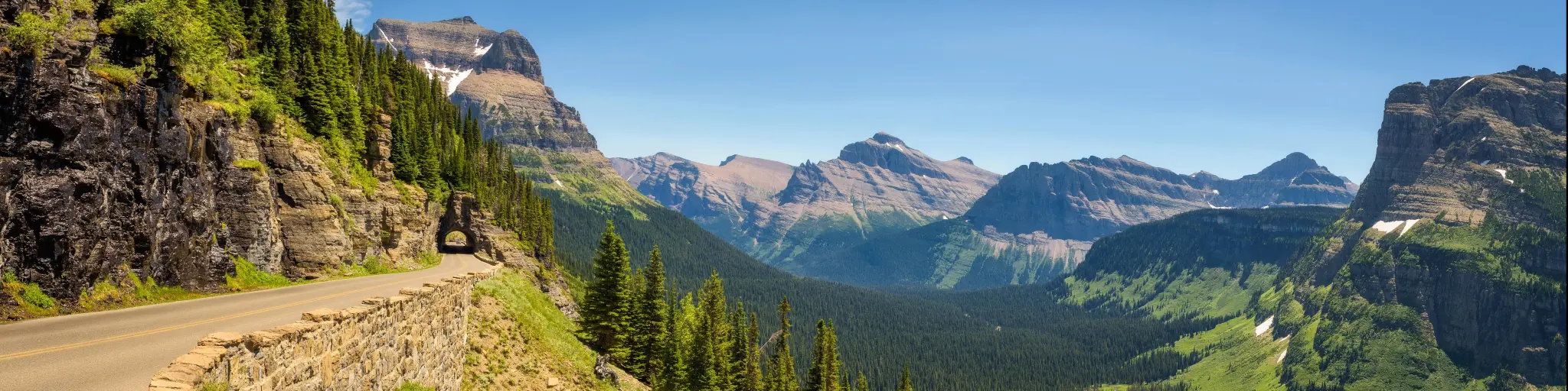 Going to the Sun Road, Montana, USA with a beautiful panoramic view of Logan Pass in Glacier National Park on a sunny day.