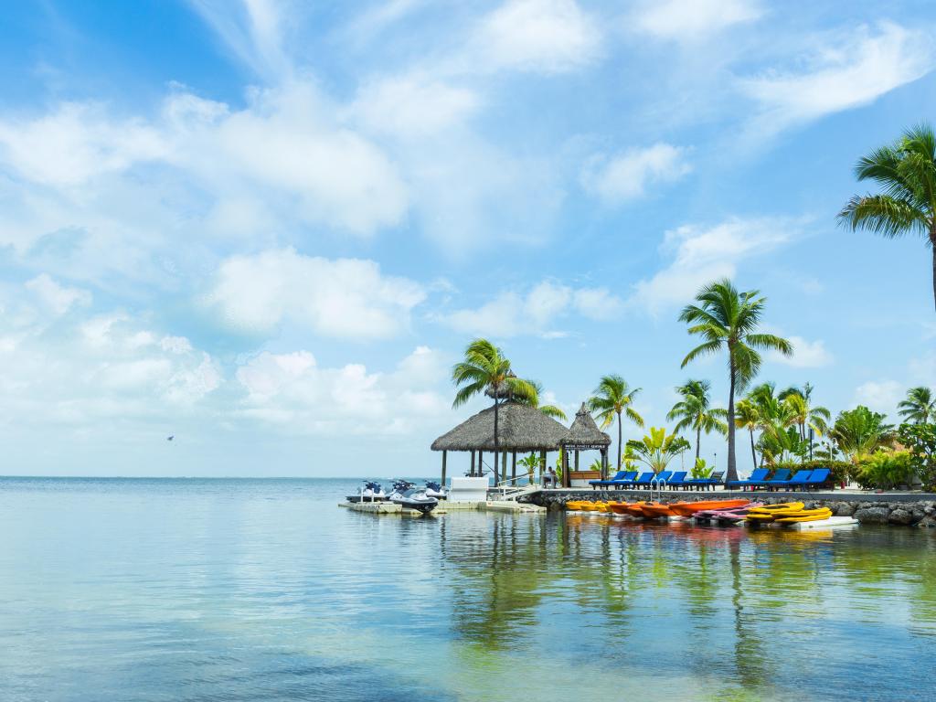 Key Largo, Florida, USA with a beautiful landscape of the sea and palm trees, a pier on a sunny day.
