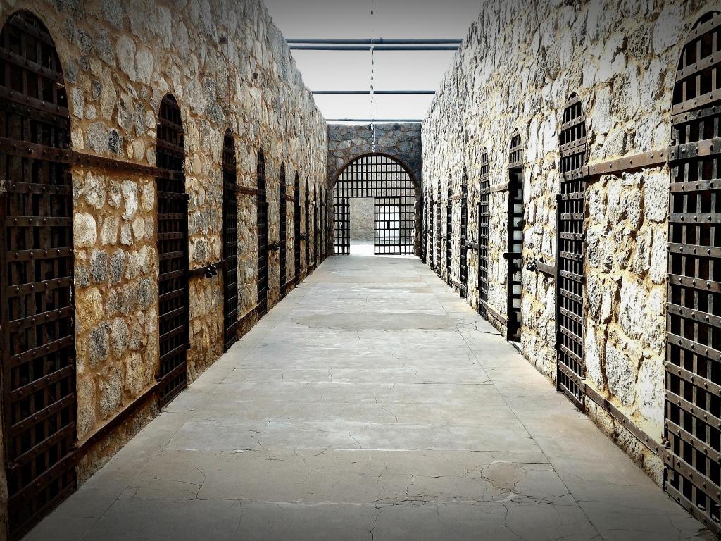 Inside of the prison, with stone walls and cells lined up