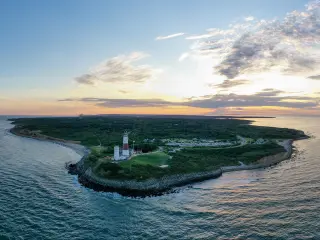 An aerial shot of the Montauk Lighthouse during a sunset