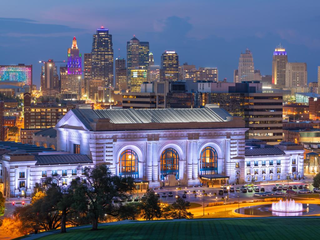 Kansas City, Missouri, USA downtown skyline with Union Station at dusk.