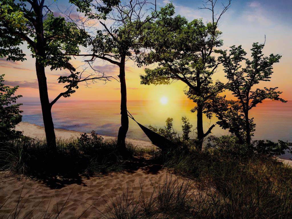 Indiana Dunes National Park, Indiana, USA with the silhouette of the park landscape overlooking Lake Michigan at sunset near Porter, Indiana.