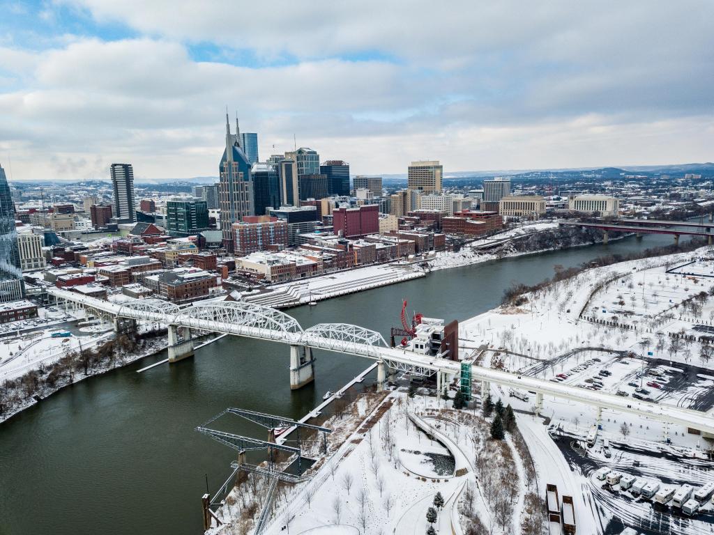 Aerial view of the city and the bridge connecting it, with a healthy covering of snow