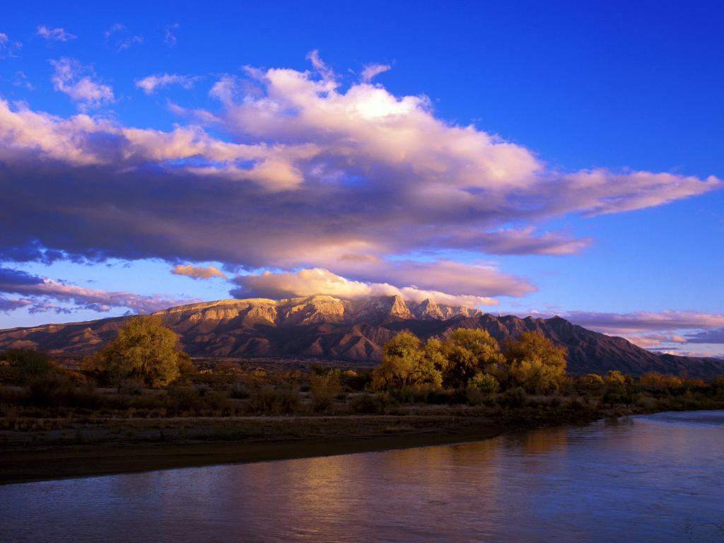 Rio Grande flowing in the foreground with Sandia Mountains seen from the town of Bernalillo, New Mexico