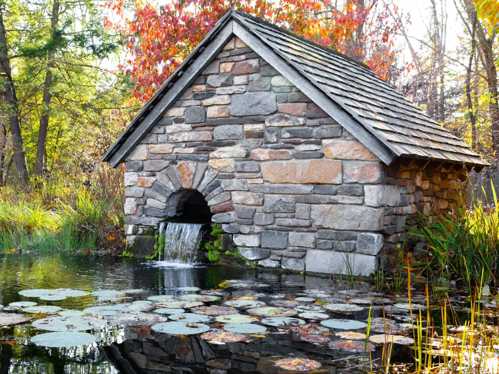 Bowman's Hill Wildflower Preserve fountain shack in late autumn,, surrounded by lilypads in the lake and forests, New Jersey